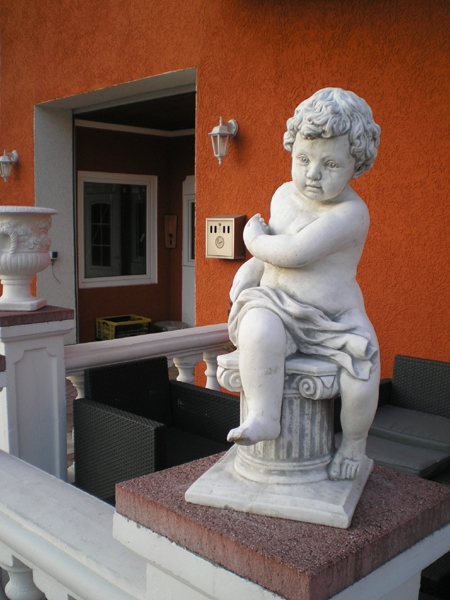 angel figure sitting on capital