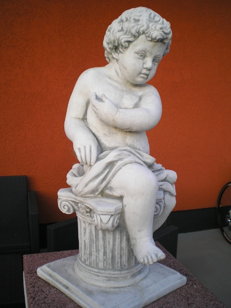 angel figure sitting on capital