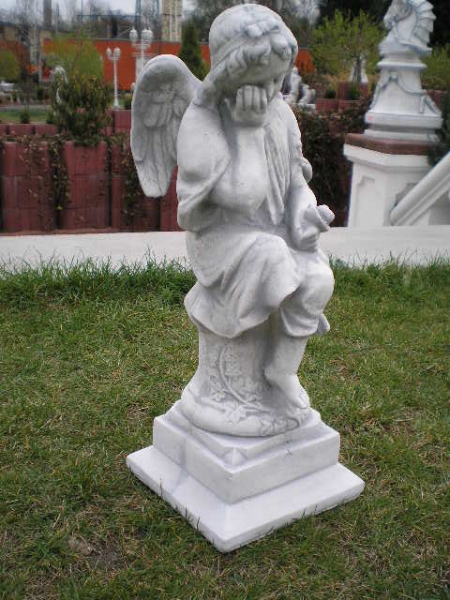 Stone statue of a "sad angel sitting on column"